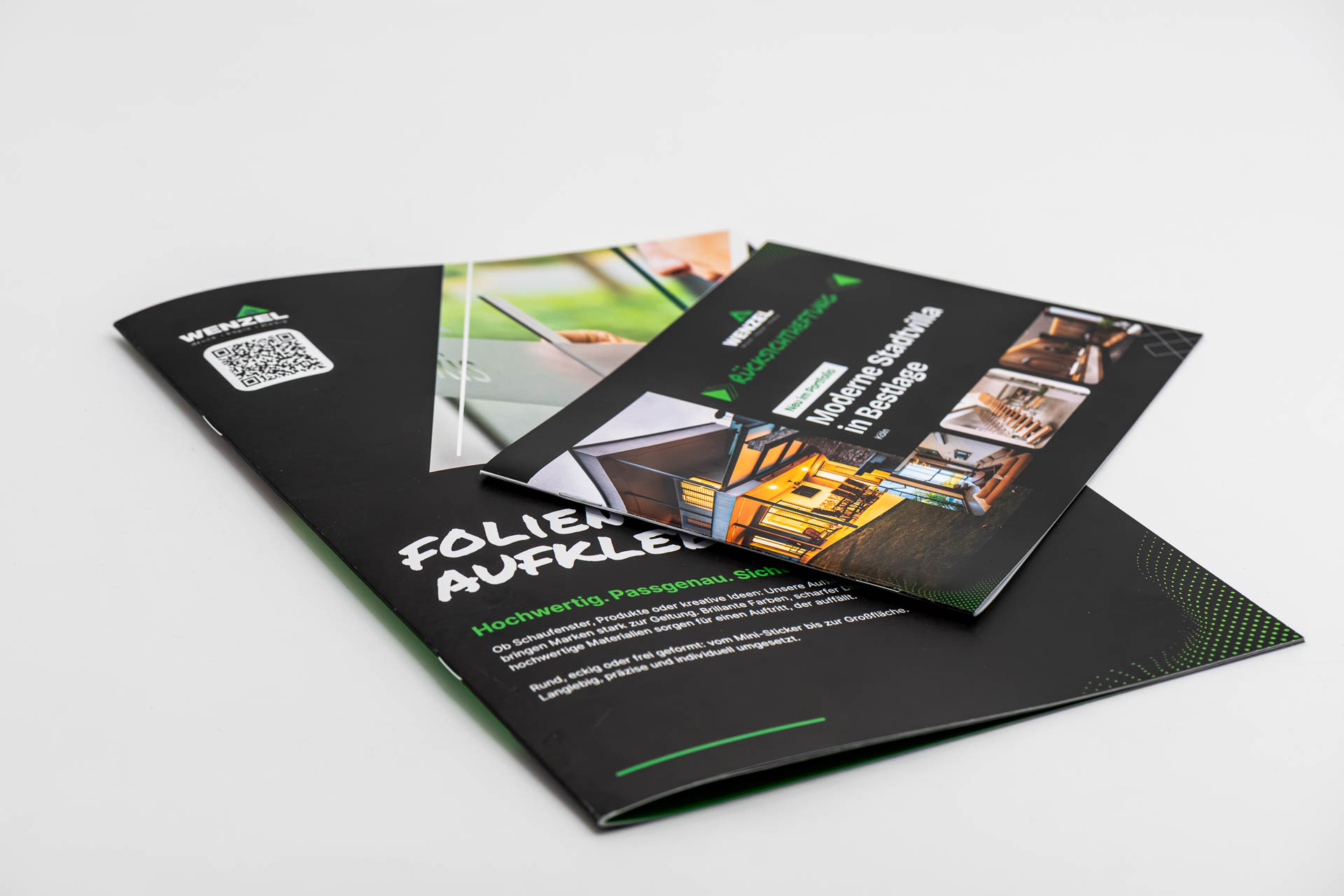 Two sample brochures, landscape format, wire-stitched