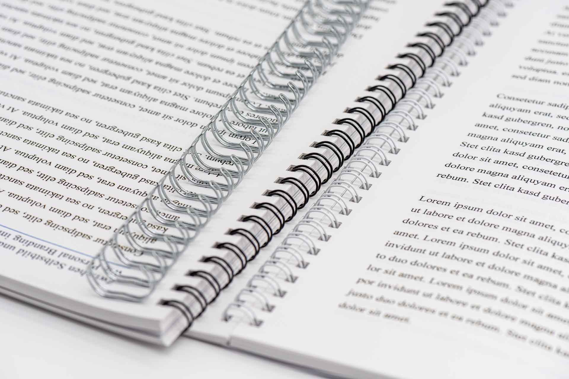 Opened brochures with spiral binding in various wire colours